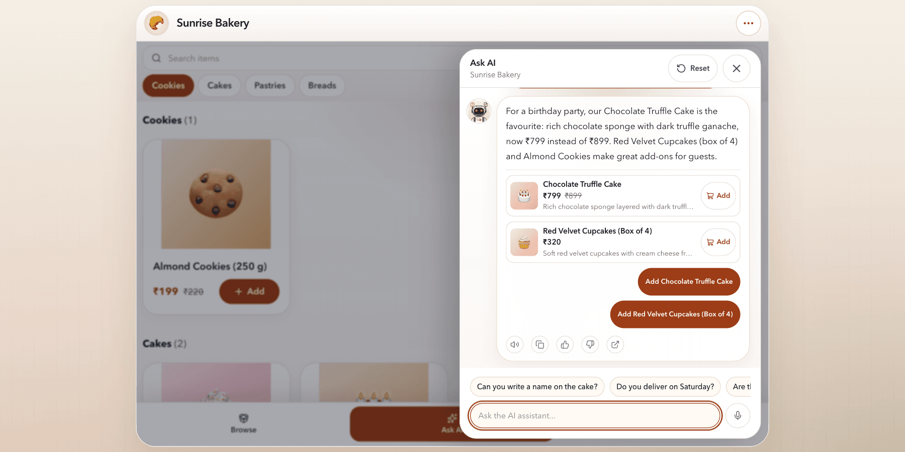 Kiosk Ask AI panel beside the catalog recommending a fictional bakery's cake and cupcakes with prices and Add buttons.